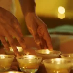a serene spa environment captures a professional therapist expertly performing back cupping therapy on a fit adult, with glass cups aligned along the spine under soft, calming lighting.
